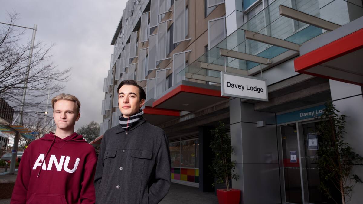 ANU students Jordan Maloney and Lawrence De Pellegrini outside Davey Lodge, which will be used to quarantine overseas arrivals on Thursday night. Picture: Sitthixay Ditthavong