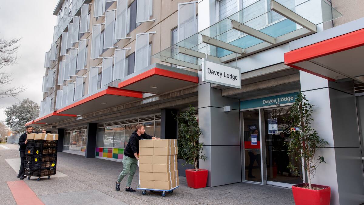 Welcome packs are carted into ANU's Davey Lodge, which will be used to quarantine overseas arrivals on Thursday night. Picture: Sitthixay Ditthavong