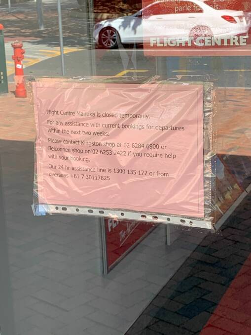 A sign posted on the door of Flight Centre in Manuka. Picture: Andrew Brown.