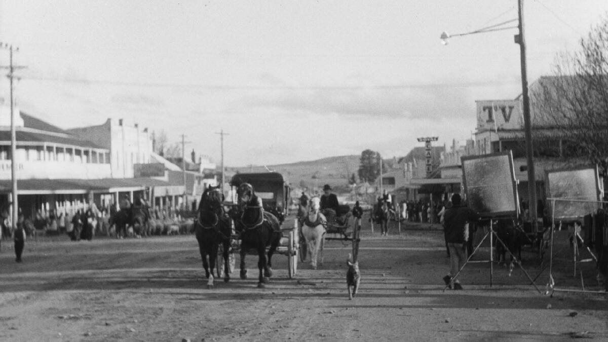 The main street of Braidwood in 1969, covered with red dirt that was especially trucked in for the filming of 'Ned Kelly' which was released in 1970. They only filmed the eastern side of the street to avoid modern signage on the western side. Picture: Neal Gowen
