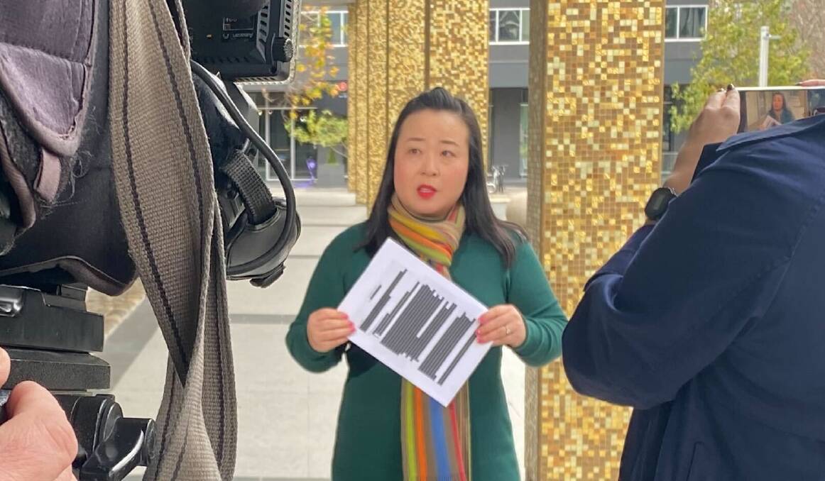 Opposition Leader Elizabeth Lee brandishing a copy of the redacted contract. Picture: Jasper Lindell 