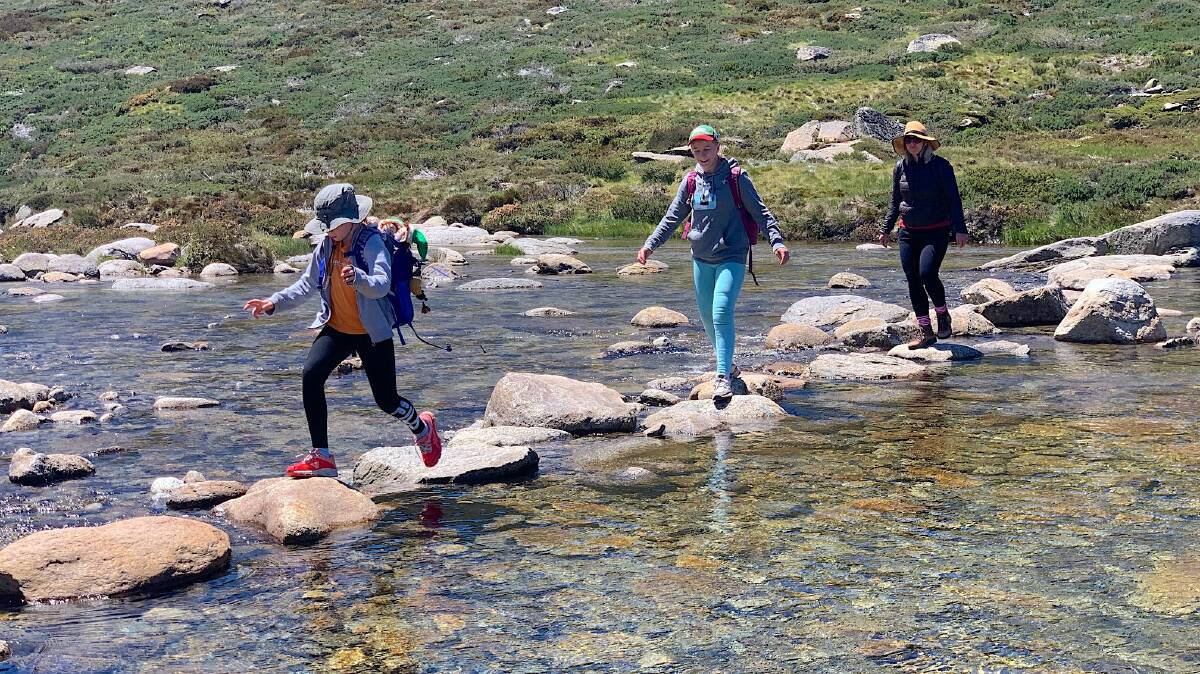 Crossing the stepping stones across the Snowy River below Charlotte Pass. Picture: Tim the Yowie Man