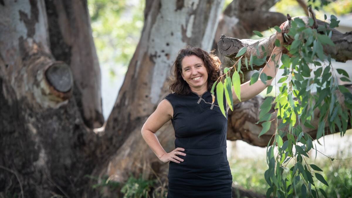 Rebecca Vassarotti in front of a red gum that is older than Canberra. Picture: Karleen Minney