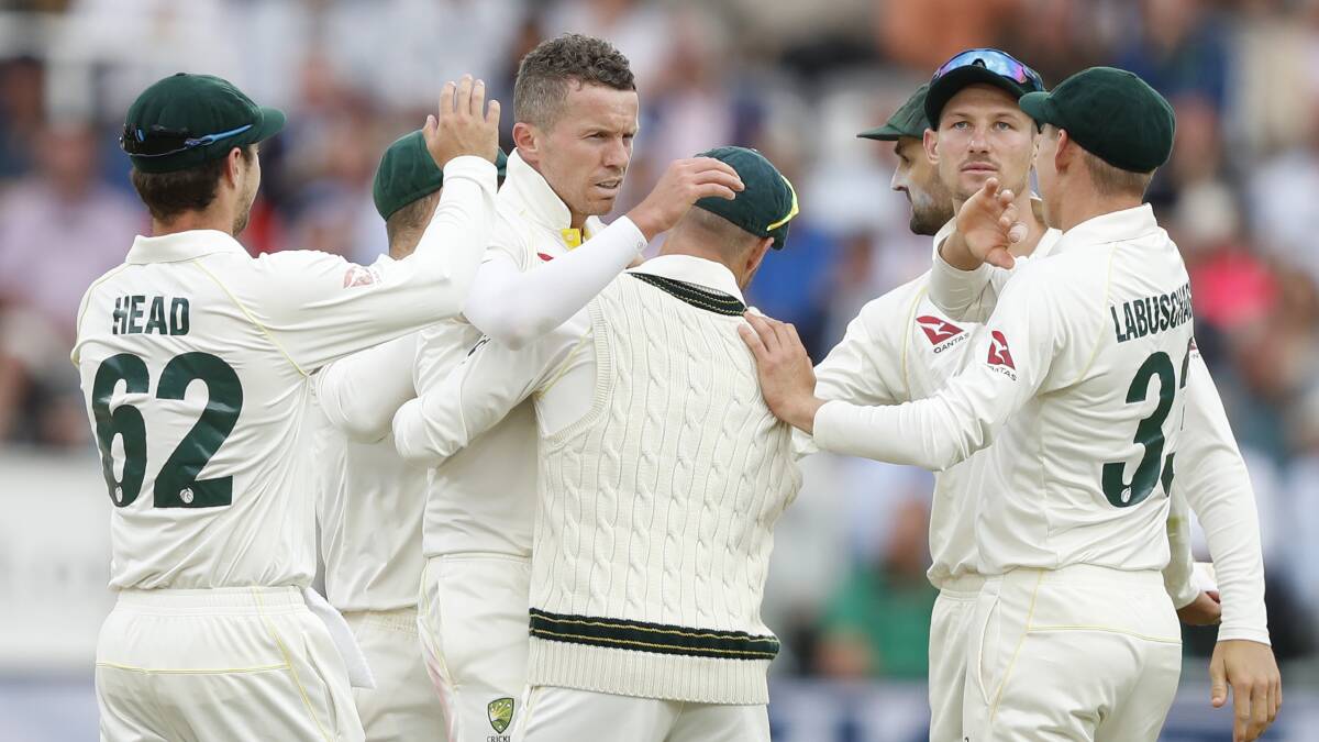 Australia's Peter Siddle, center, celebrates with teammates after taking the wicket of England's Joe Denly. Picture: AP