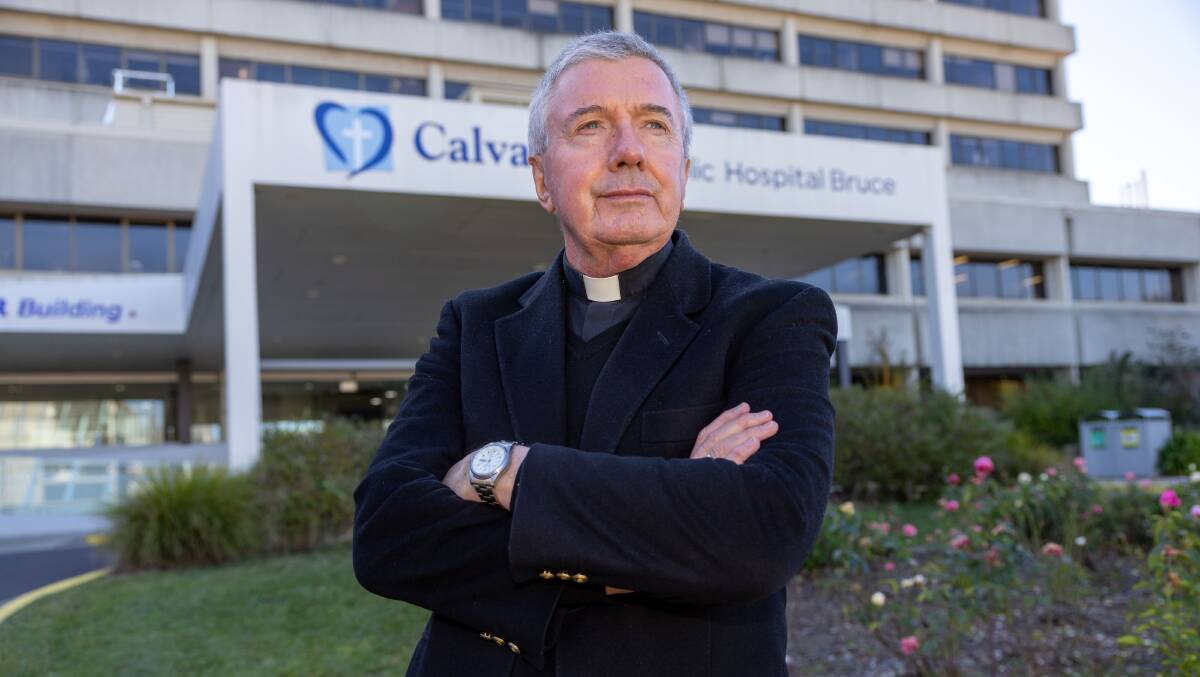 Archbishop Christopher Prowse outside Calvary Hospital before it was acquired by the ACT government. Picture by Gary Ramage