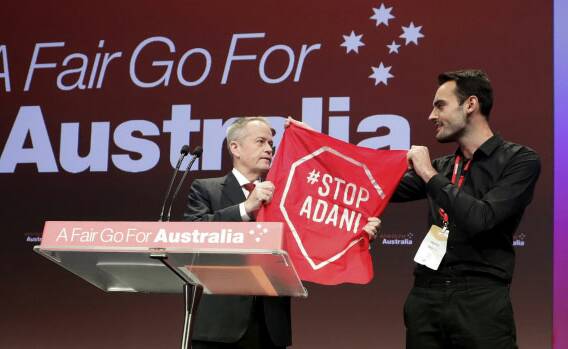 The moment when Mr Shorten is forced to confront an anti-Adani protestor on stage. Photo: Alex Ellinghausen