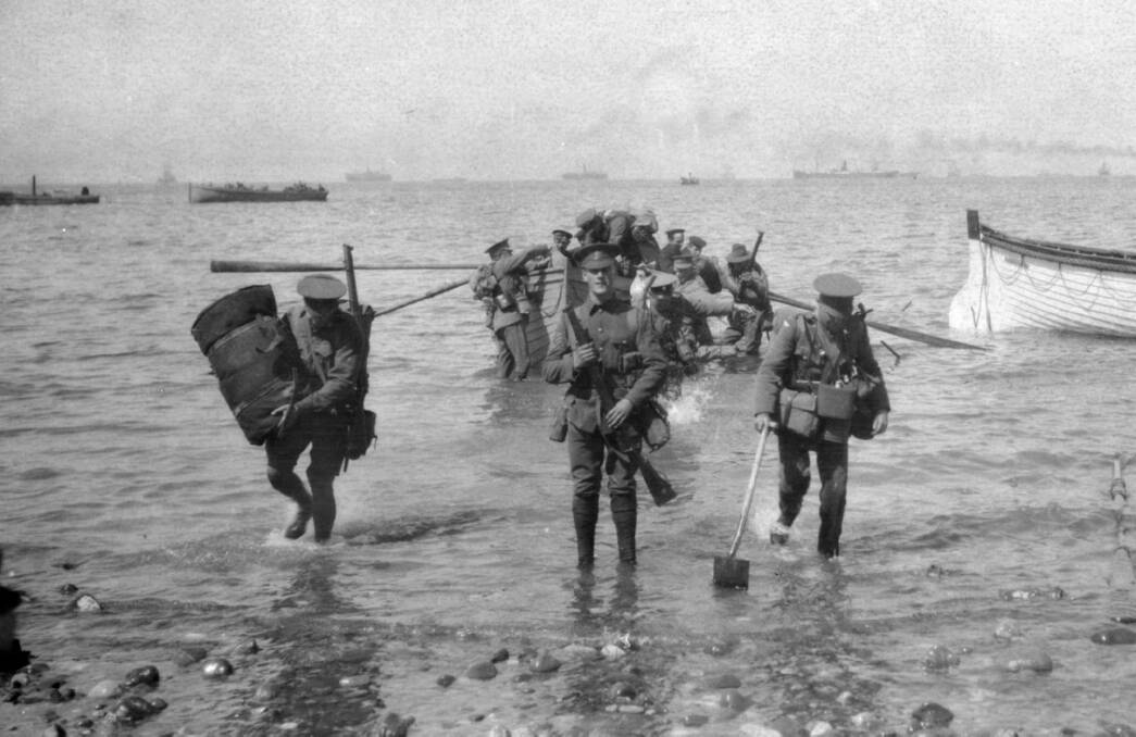 April 25, 1915: Divisional headquarters staff wade ashore at Anzac Cove. Picture by Charles Bean/AWM G00903