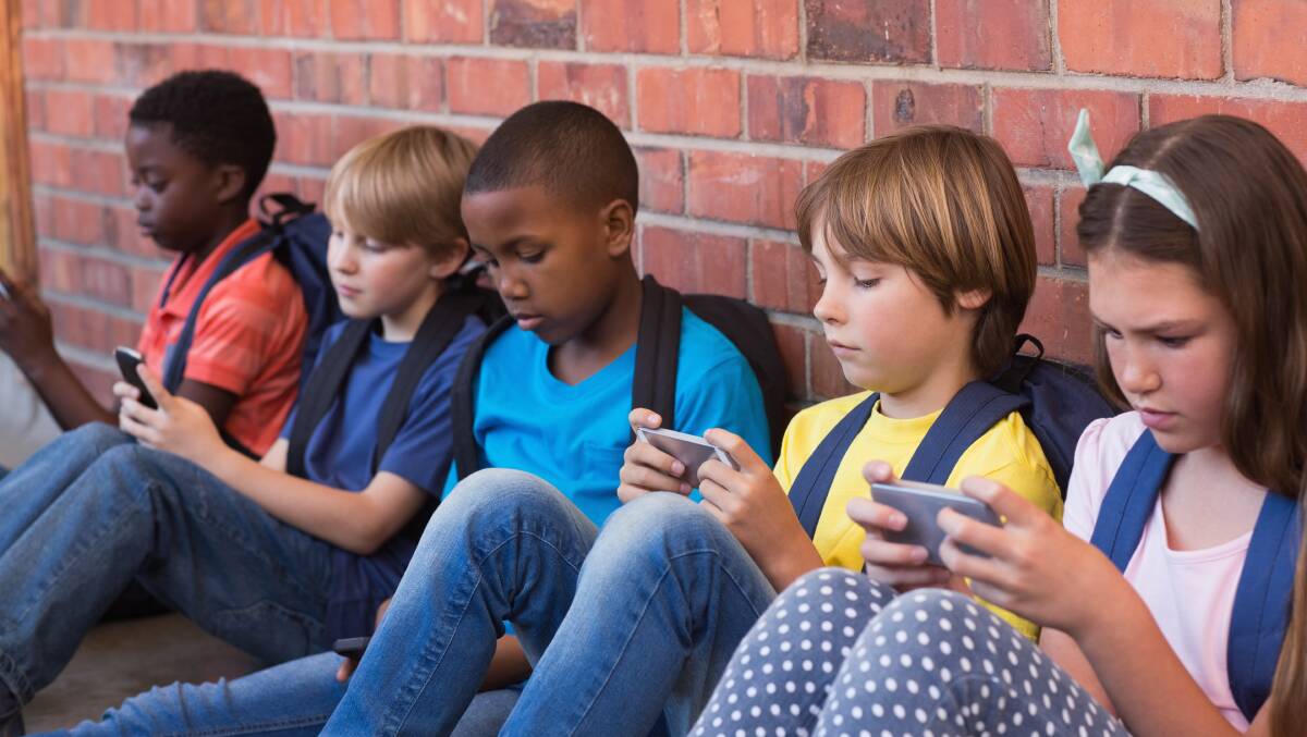 Kids on phones just endlessly scroll and don't engage with other kids. Picture Shutterstock