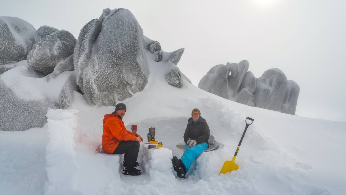 Susan Bruce and Tony Brown tuck into breakfast at the 'Ramshead Café' above Thredbo. Picture: Mike Edmondson