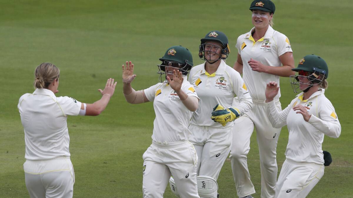 Australia players celebrate with Jess Molineux, left, celebrates after taking the wicket of England's Anya Shrubsole. Picture: AP