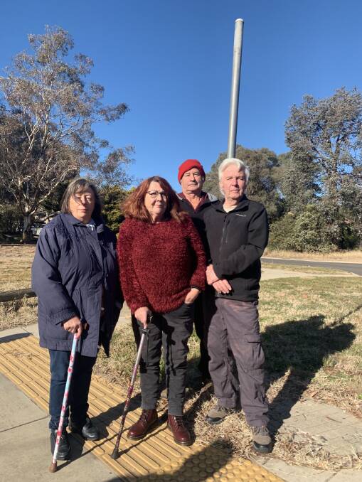 Wanniassa residents Rebecca Lamb, Chris Hastir, Arthur Abraham and Geoffrey Lamb at a decomssiioned bus stop. 