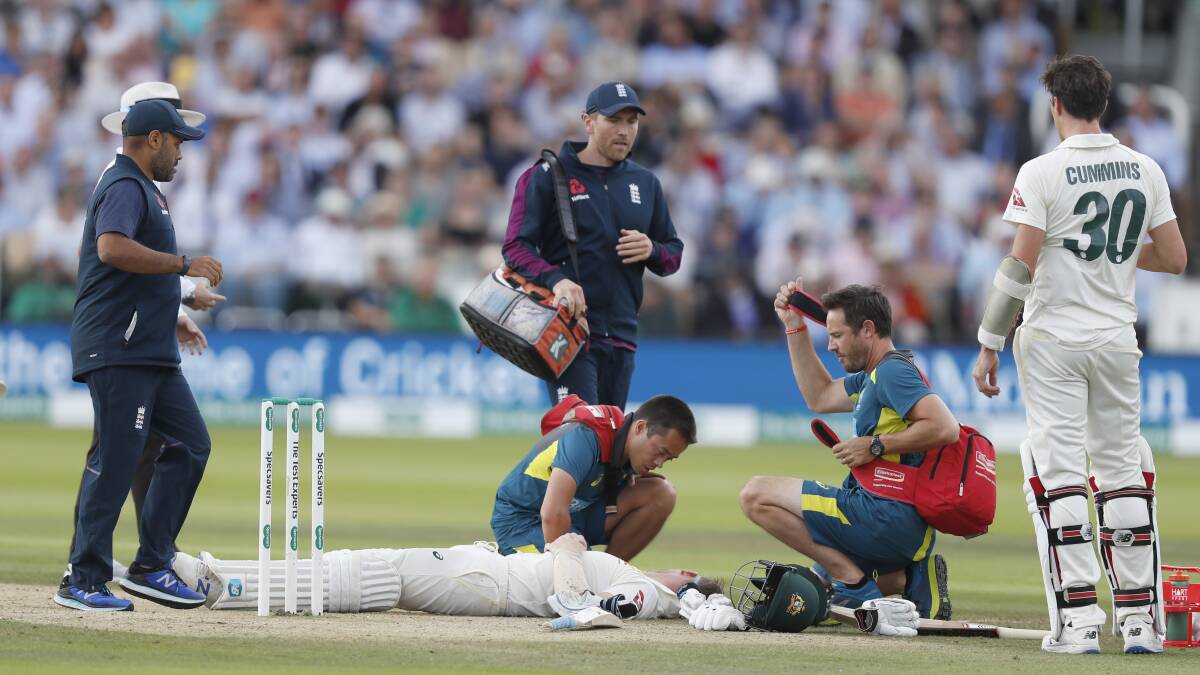 Steve Smith receives treatment as lies on the ground after being hit on the head by a ball bowled by England's Jofra Archer. Picture: AP