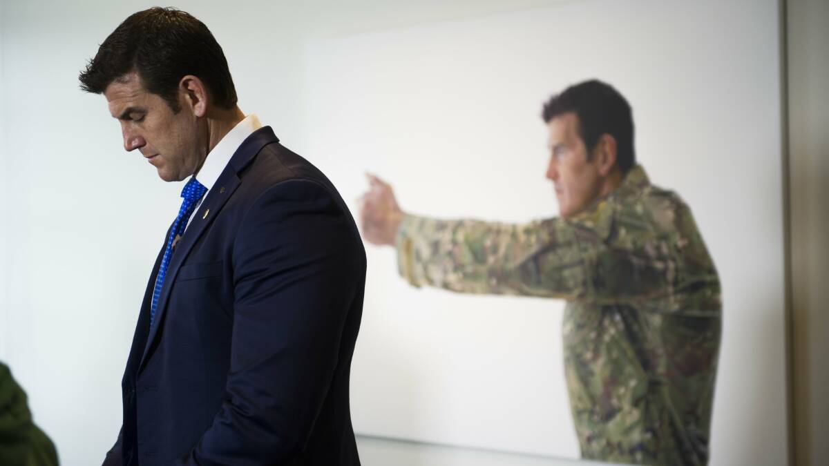 Ben Roberts-Smith with a portrait of him at the Australian War Memorial. Picture by Jay Cronan