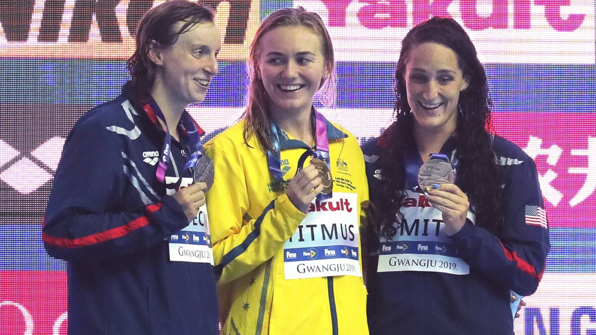 Katie Ledecky of United State, silver, Ariarne Titmus of Australia, gold, and Leah Smith of US, bronze, celebrate on the podium of the Women's 400m Freestyle. Picture: AP