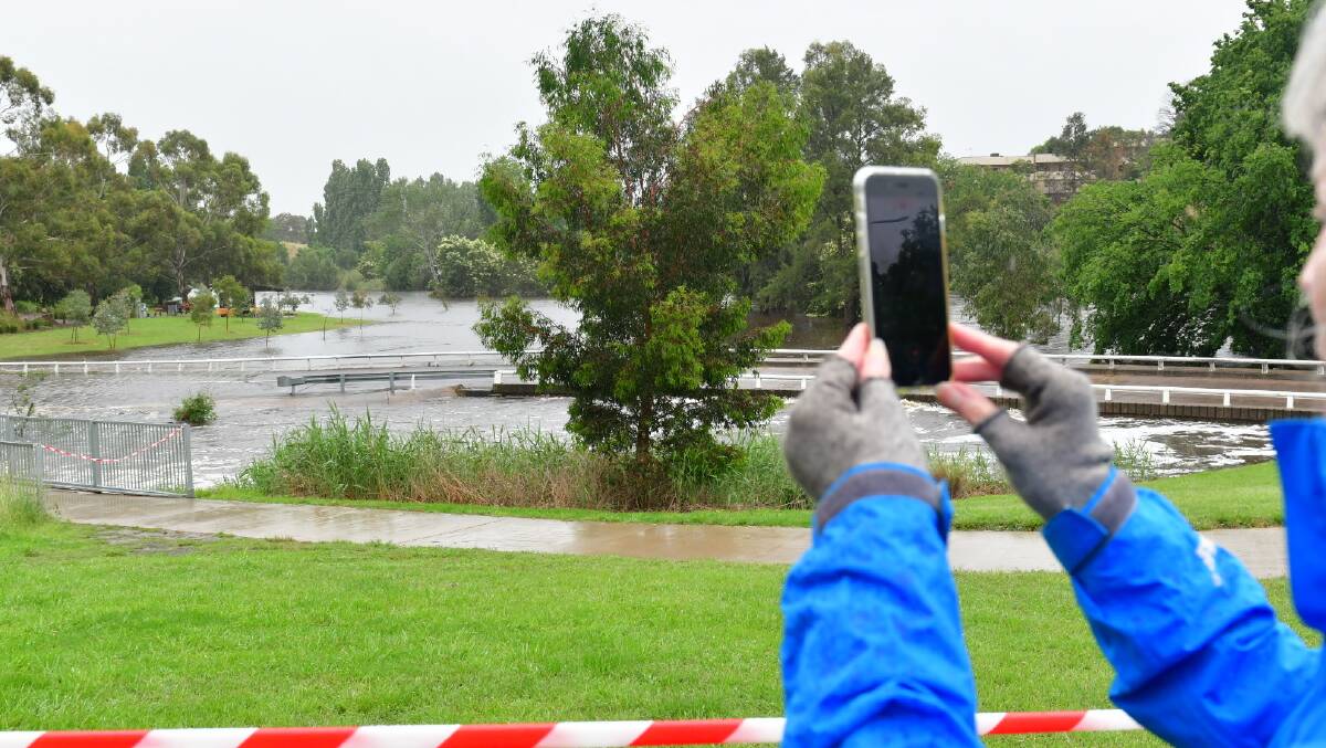 Linda from Bungendore takes a photo of the river. Picture: Elesa Kurtz