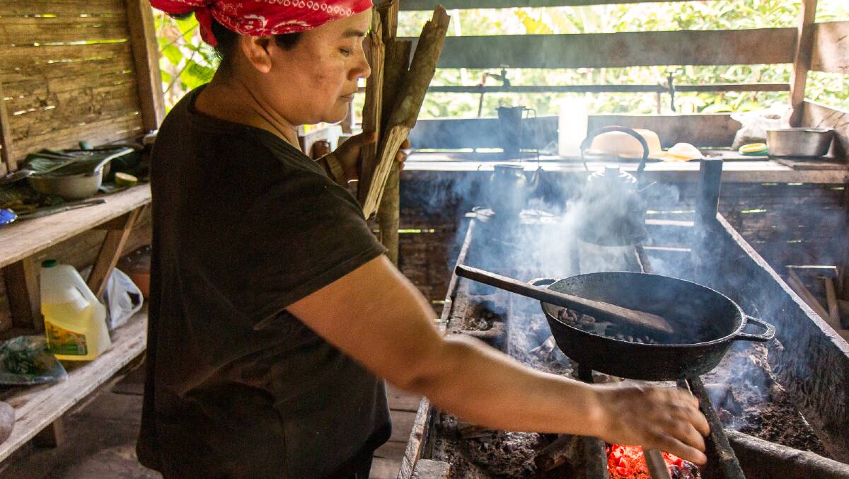 A Bribri woman heats the cacao beans as part of the process to make chocolate. Picture by Michael Turtle