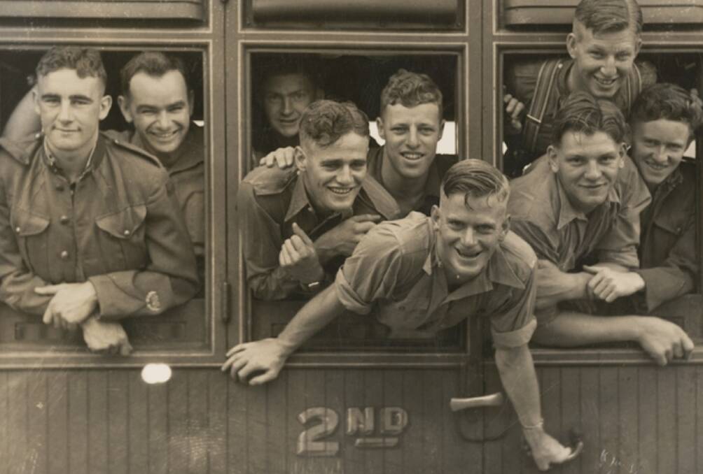 Group portrait of Australian soldiers from the 3rd Battalion (Werriwa Regiment) departing for overseas service from Canberra railway station. Identified, leaning from the train window is Lieutenant Edward "Bill" Dullard. Picture Australian War Memorial P11312.001