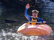 Adam Farquharson paddles down the Tumut River in a giant pumpkin. Picture by John Stanfield/Tumutians