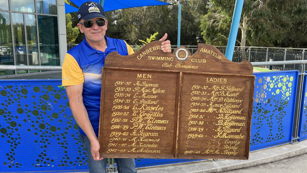 Canberra Amateur Swimming Club president Karl Willett with the returned champions board, photographed outside the Gungahlin Leisure Centre. Picture by Mandy Crampton