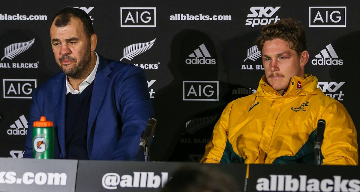 Wallabies coach Michael Cheika speaks alongside team captain Michael Hooper during a post-match press conference. Picture: AAP