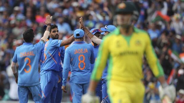 India's Bhuvneshwar Kumar, second left, celebrates with teammates the dismissal of Australia's Marcus Stoinis. Picture: AP