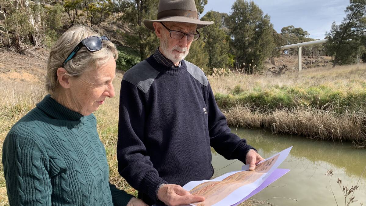ANU academics Emeritus Professor Ken Taylor and Dr Mary Hutchison attempt to discover the location of Hoddle's painting of Ginninderra Creek. Picture: Tim the Yowie Man