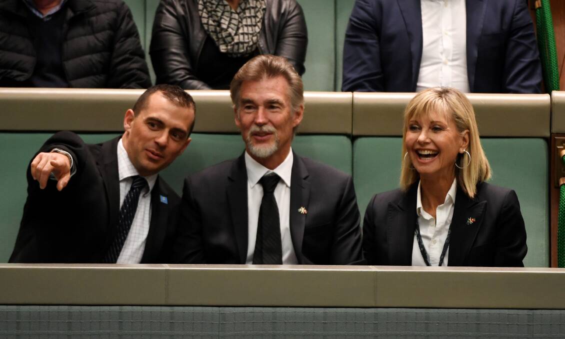 Olivia Newton-John in the public gallery with her husband John Easterling (middle) Picture: Getty Images