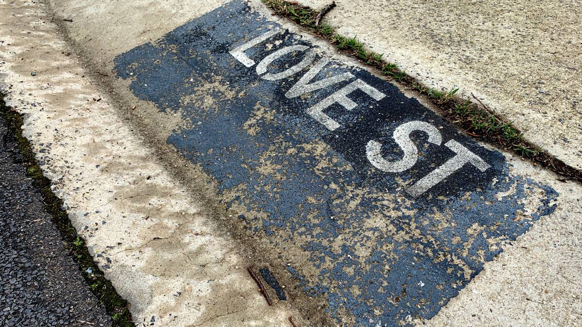 After being stolen on several occasions, the name of Love Street in Flynn has been stencilled on the kerb. Picture: Tim the Yowie Man