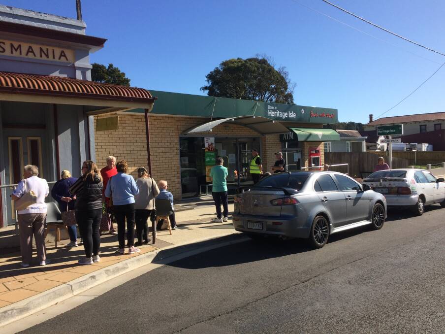 CLOSing: Beaconsfield residents queue outside of the Bank of Heritage Isle branch after hearing news of the branches closure. Picture: Supplied 