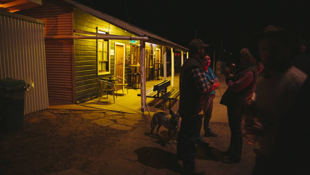 Locals have a yarn by the fire outside the Tilpa pub. Picture: Dion Georgopoulos