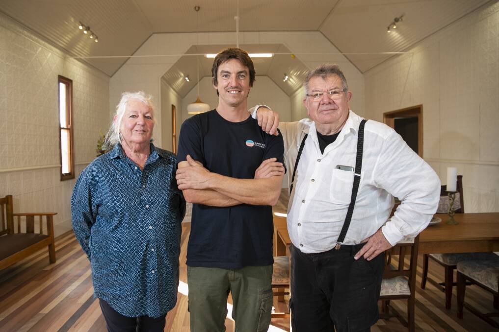Vanessa and Peter Williams with builder Peter Jirgens in the rebuilt Mogo church. Picture: Keegan Carroll