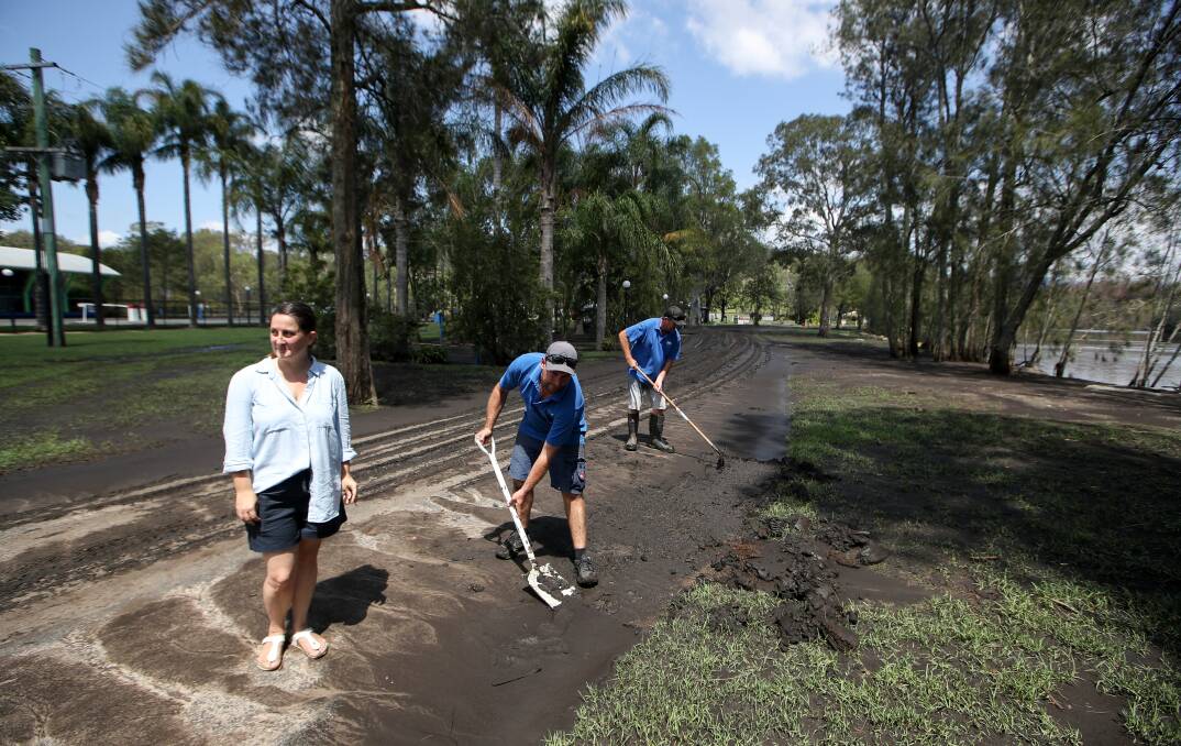 Jaclyn Geurin, Pete Graham and Tod Sutherland clean up the Big4 Nelligen Holiday Park after the flood. Picture: Adam McLean