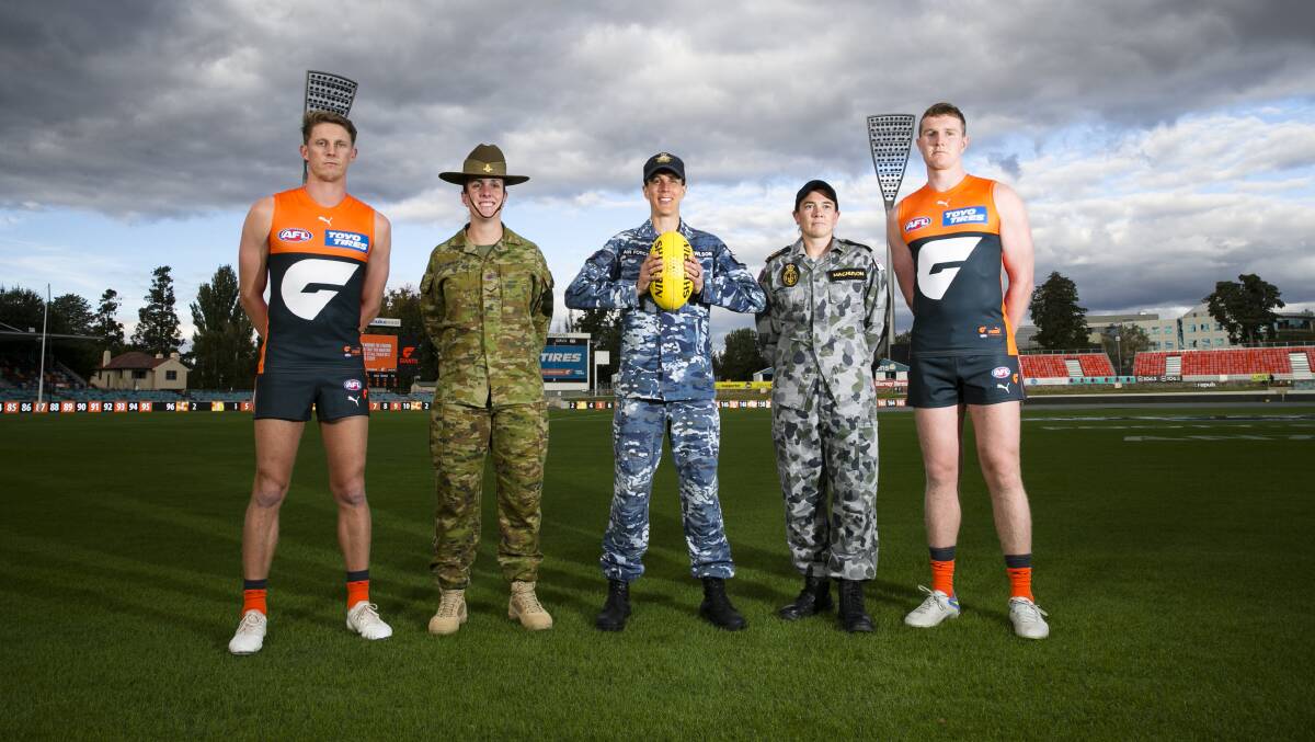 GWS Giants players Lachie Whitfield and Tom Green with Defence personnel Sara Schirripa, Liz Wilson, and Meg Magnuson at Manuka Oval. Picture: Keegan Carroll