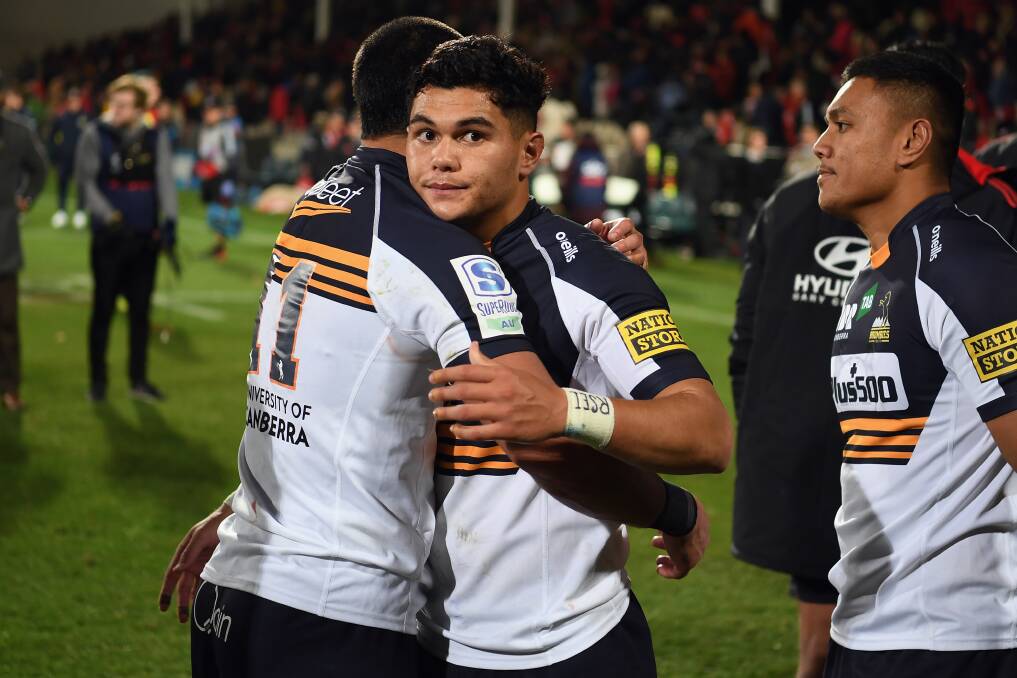 Noah Lolesio is embraced by teammate Tom Wright after the loss to the Crusaders in Christchurch on Saturday. Picture: Getty Images