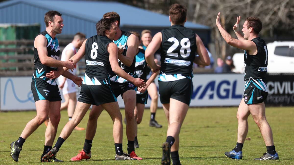 The Belconnen Magpies celebrate a goal on Saturday during their 11-point win over Ainslie Tricolours. Picture: James Croucher