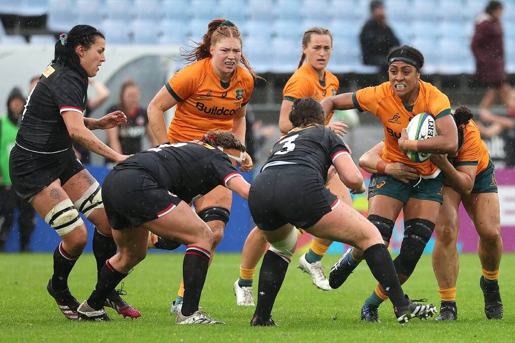 Australia's Sera Naiqama carries the ball (right) with Wallaroos debutant Grace Kemp behind (left) against Canada. Picture: Getty