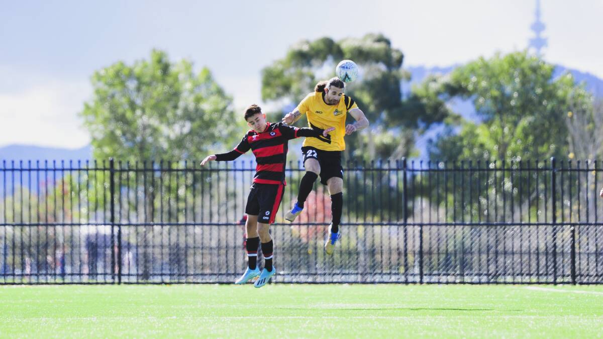 West Canberra Wanderers FC's Alessandro Pena Alcazar and Tigers FC's Christian Junna header the ball. Picture: Dion Georgopoulos
