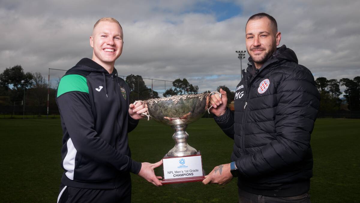 Monaro Panthers' Jordan Thurtell and Canberra Croatia captain Matt Grbesa with the NPL men's grand final trophy. Picture by Sitthixay Ditthavong