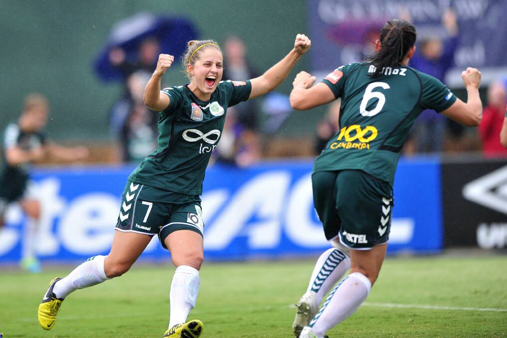 Ellie Brush celebrating a goal with former Canberra United teammate Caitlin Munoz - who is one of the club's mentors this season - in 2014. Picture: Jeffrey Chan