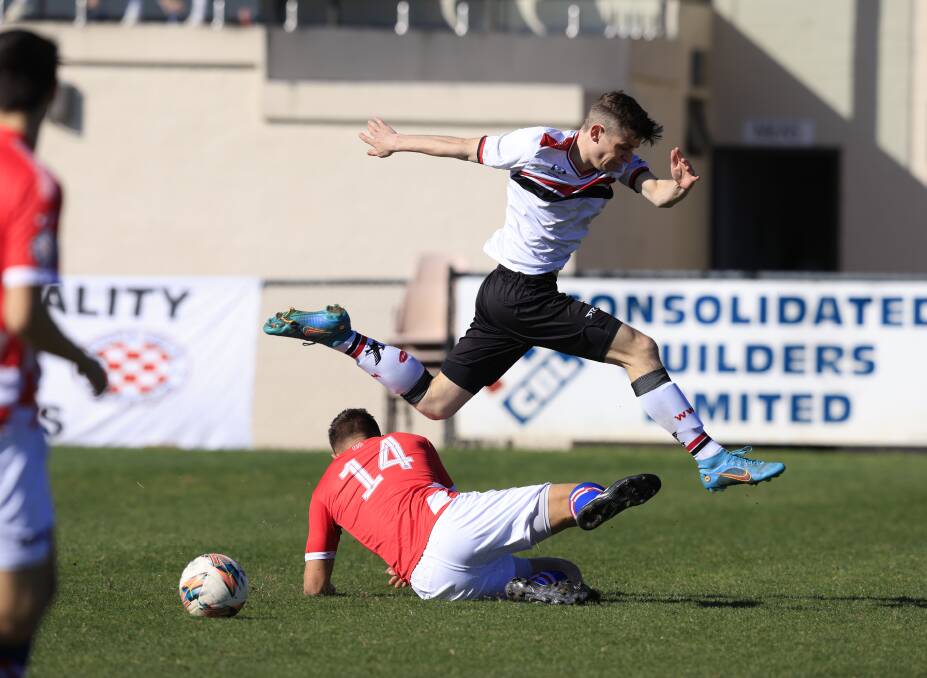 West Canberra Wanderers Harrison Palic jumps over a contest at Deakin Stadium on Sunday. Picture by Keegan Carroll