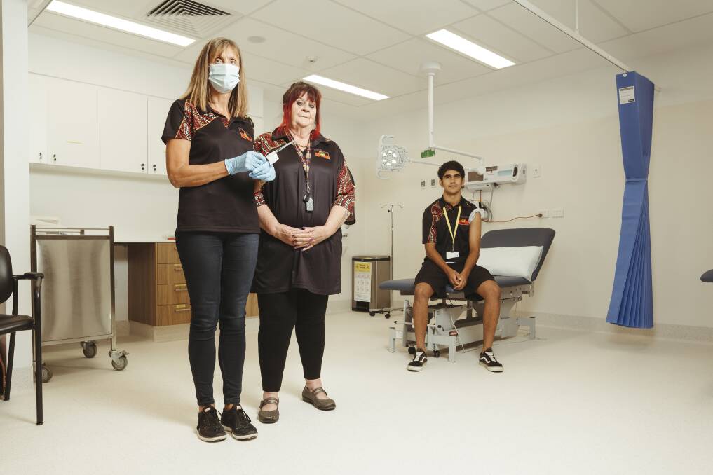 Winnunga Nimmityjah Aboriginal Health Service practice nurse manager Michele Clarke, chief executive Julie Tongs, and receptionist Connor Williams, who have all received a COVID-19 vaccine. Picture: Dion Georgopoulos