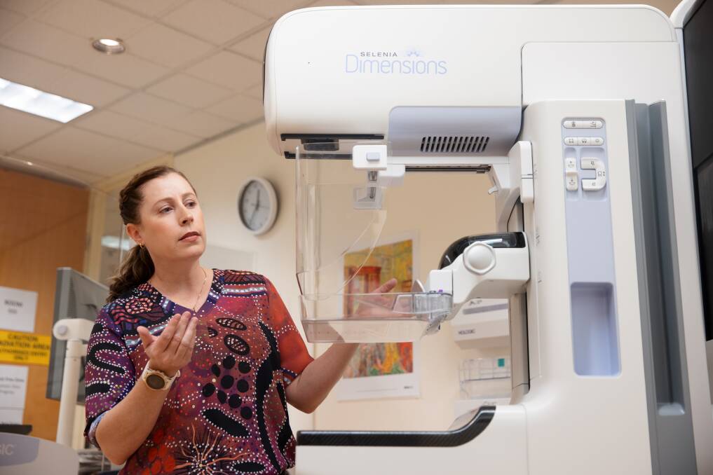 Radiographer Mary Humphrey explaining the breast cancer screening process. Picture: Sitthixay Ditthavong