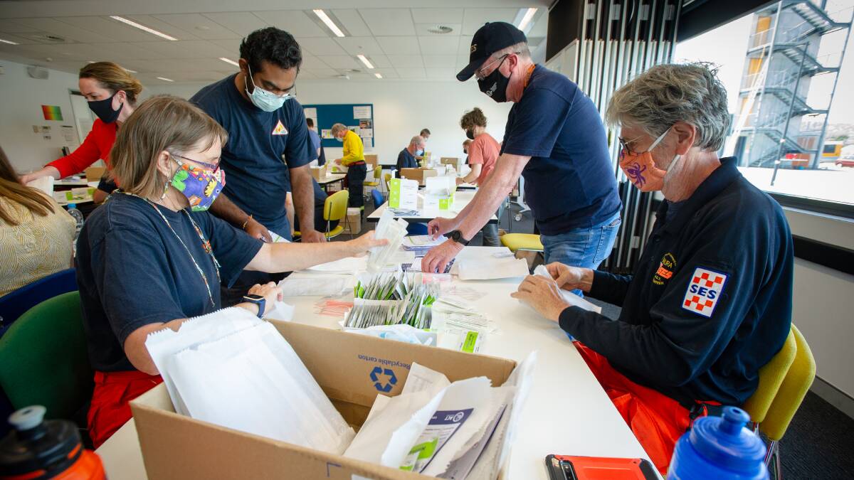 ESA staff unpacking a stockpile of rapid antigen tests that have landed in the ACT. Picture: Elesa Kurtz 