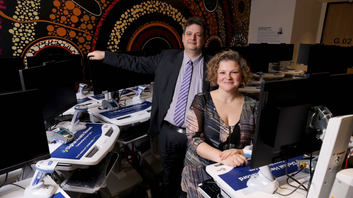 ACT Health chief information officer Peter O'Halloran and chief nursing and midwifery officer Rebecca Heland with some of the machines that will be used for the digital health record. Picture: James Croucher