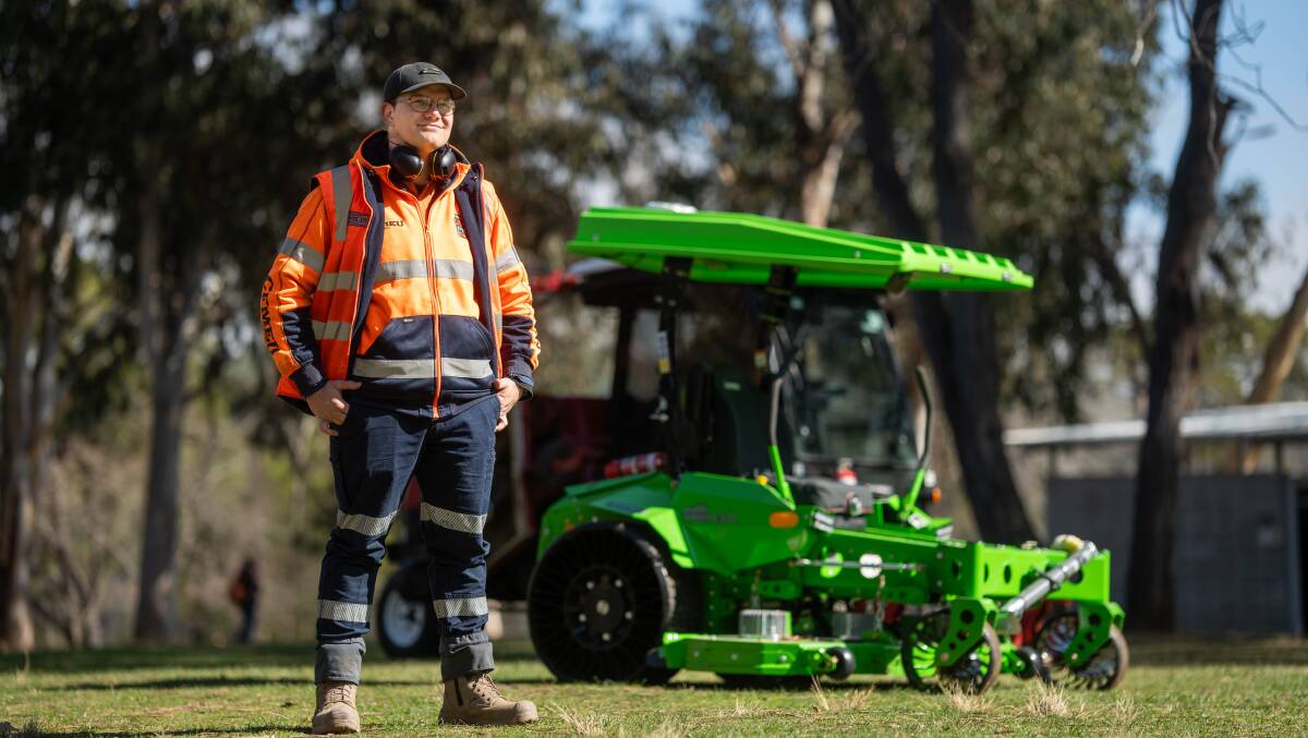 Angus Greene, who works in the government's mowing team, standing in front of one of the new electric mowers. Picture supplied
