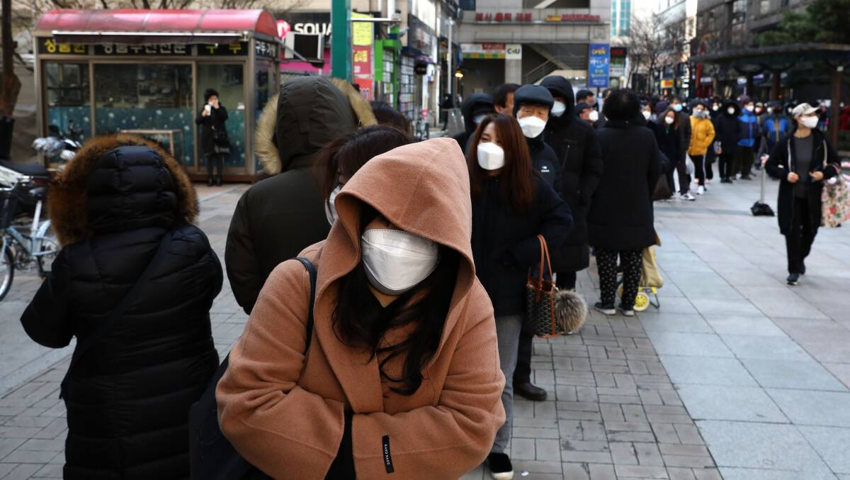 People in South Korea line up to buy face masks. The travel ban on people from China and Iran has similarly not been replicated for countries such as Italy and Korea. Picture: Getty Images
