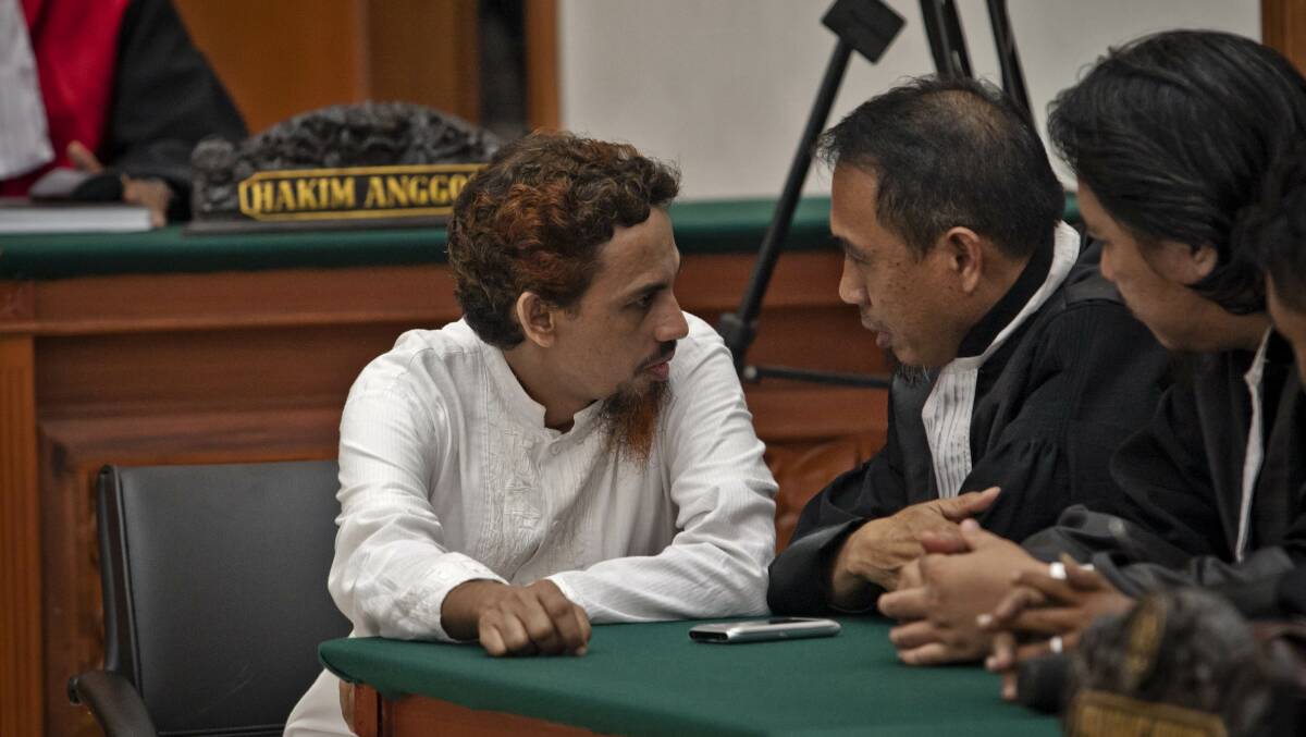 Umar Patek speaks with his lawyer in the court room during the Bali bombings verdict trial on June 21, 2012. Picture Getty Images