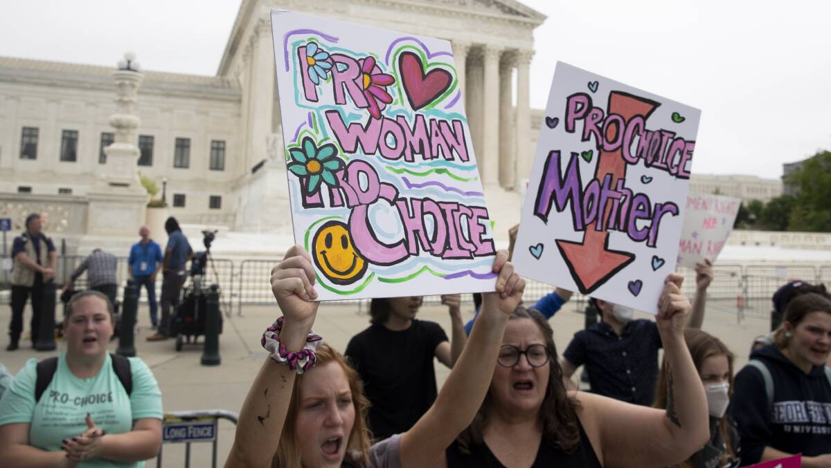 Abortion rights advocates hold signs outside the Supreme Court in Washington, DC on Wednesday. Picture: AAP
