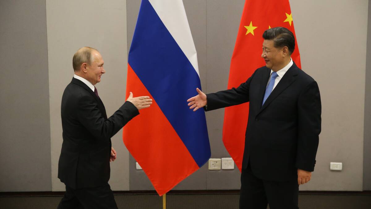 Russian President Vladimir Putin greets Chinese President Xi Jinping. Picture Getty Images