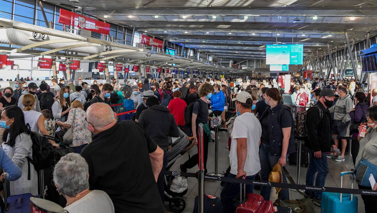 Queues of people are seen at the Virgin and Jetstar departure terminal at Sydney Domestic Airport in Sydney on Thursday. Picture: AAP